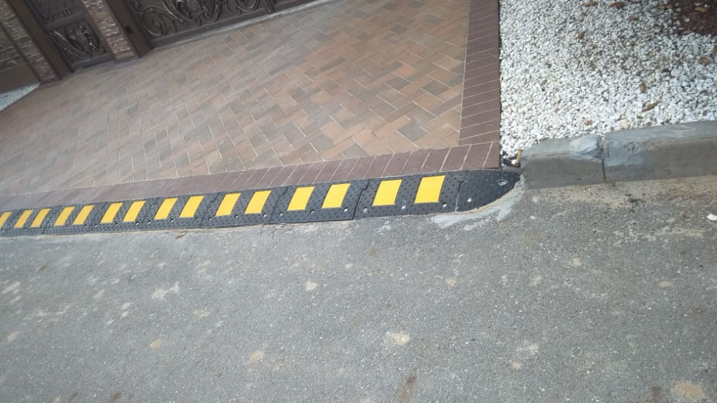 Место примыкания тротуара и дороги, оформленное резиновым съездом с бордюра Место примыкания тротуара и дороги, оформленное резиновым съездом с бордюра